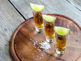 glas tequila på träplattan foto