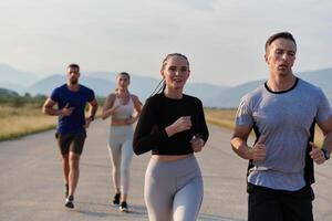 en grupp av vänner hävdar en friska livsstil förbi löpning utomhus på en solig dag, bindning över kondition och njuter de energigivande effekter av övning och natur foto