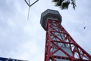 fukuoka, japan - december 7 2022 - ser upp se av hakata hamn torn, en röd gitter metall observation torn foto