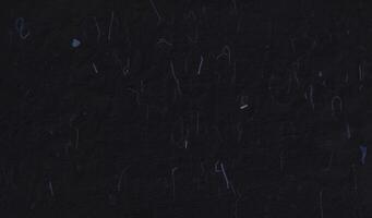 handgjort ris svart papper textur med blå fibrer för klippbok. foto