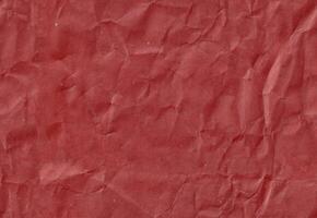 sömlös skrynkliga mörk röd hantverk papper textur. gammal klippbok papp. foto