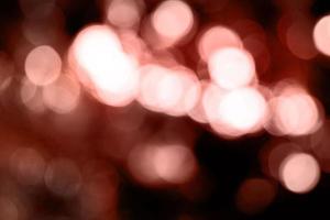 mångfärgad mörkröd oskärpa bakgrund och cirkel bakgrund och abstrakt cirkel oskärpa julljus effekt foto