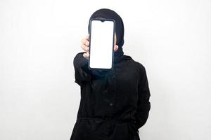 muslimsk kvinna med händer som håller smartphone, marknadsför app, marknadsför något, isolerad på vit bakgrund, reklamkoncept foto