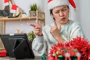 asiatisk kvinna fira nyår och julfest med surfplatta videosamtal vänner hemma