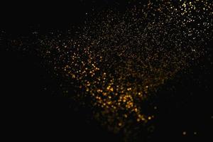 guld abstrakt mönster glitter stardust gnistrande ljus grunge på svart. foto