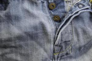 gamla grunge vintage jeans. sydd textur denim jeans bakgrund av jeans modedesign. foto