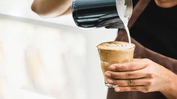 professionell barista som gör latte art kaffe foto