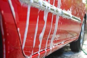 tvättar röd bil foto