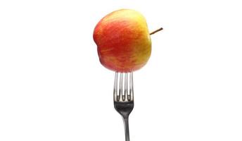 hälsosam kost. viktkontroll. äpple på gaffel mot vit bakgrund. hälsosam mat koncept. foto