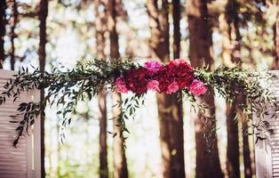 bröllopsbåge dekorerad med ljusa blommor foto