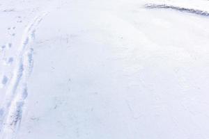 fotspår av en man och en hund på ett snöigt fält foto