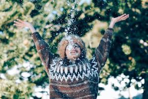 ung kvinna njuter av de snöiga bergen på vintern foto