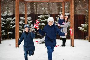 familj med danmarksflaggor utomhus på vintern. resa till skandinaviska länder. lyckligaste danskarnas . foto