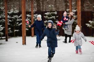 familj med danmarksflaggor utomhus på vintern. resa till skandinaviska länder. lyckligaste danskarnas . foto