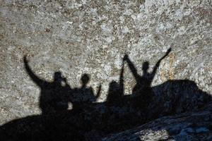 skuggan av en grupp människor på en sten foto