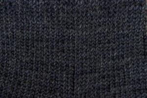 textur av ett svart tyg. stickning foto