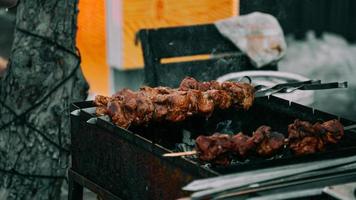 närbild av några köttspett som grillas i en grill utomhus foto