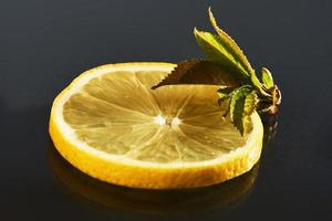 färska saftiga skivor citron på en svart bakgrund foto