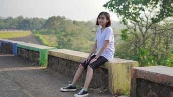 ung asiatisk kvinna vilar efter en jogging foto