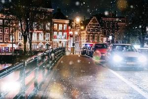 amsterdam kanaler västra sidan i skymningen nederländerna under en snöstorm. bokeh ljuseffekt, mjukt filter foto