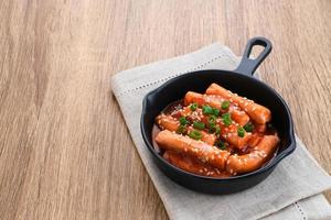 tteokbokki eller topokki , wokad riskakepinne, populär koreansk gatumat med kryddig gochujang-sås och sesamfrö. foto