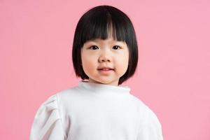 härlig baby flicka porträtt, isolerad på rosa bakgrund foto