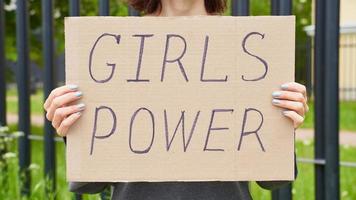 girl power koncept. oigenkännlig person håller skylt med text om feminism foto
