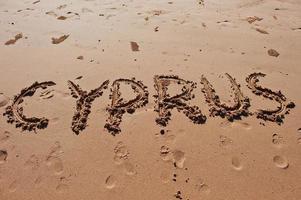 Cypern skrivet i sanden på stranden foto
