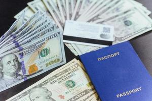 ovanifrån av pass med dollarsedlar på trä skrivbord foto