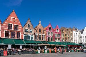 brugge, belgien, 2015. historiska gavelbyggnader och kaféer på torget i brugge foto