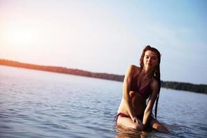 ung vacker flicka poserar på stranden foto