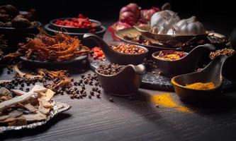 kryddor eller kryddor för röd curry eller thaimat. ingredienser mat kryddor peppar, korianderfrön, torkad chili, gurkmeja, vitlök. foto