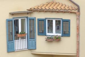 fönster och balkong med blå träluckor foto