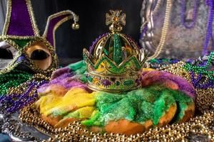 färgglad kungstårta med krona omgiven av mardi gras pärlor foto