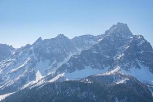 vackra majestätiska kronplatz bergskedja mot klarblå himmel på vintern foto