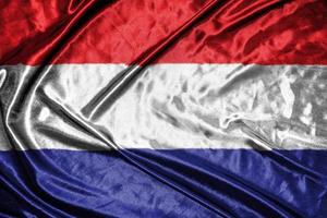 nederland tyg flagga satin flagga viftande tyg textur av flaggan foto