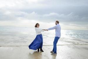 ett älskande par, man och kvinna som njuter av sommarlovet på en tropisk paradisstrand med klart havsvatten och natursköna foto