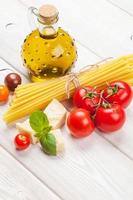 pasta, tomater, basilika på träbord
