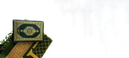 bilder på koranen och bönemattor redo för ramadan. arabiska på omslaget översätts som koranen foto