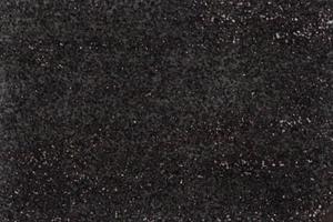 sand stenvägg svart färg grov ytstruktur material bakgrund prick vit mönster foto