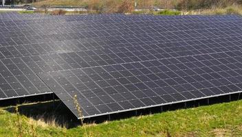 genererar ren energi med solcellsmoduler i en stor park nära motorvägen A7 i norra Tyskland. foto