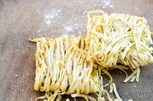 färsk pasta bo på träbord foto