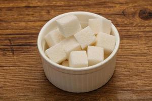 raffinerade vita sockerbitar i skålen foto