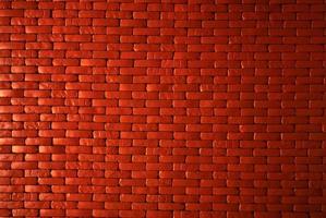 orange tegelvägg textur bakgrund. murverk för hemarkitektur interiör. loftdesign av hemmet. röd tegelvägg vintage bakgrund. murningsarbete. bostadsbyggande. tegelväggmönster. tom vägg. foto