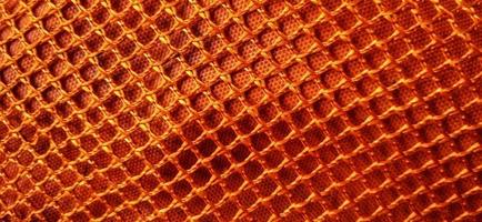 guld orange honeycomb nätmönster bakgrund. syntetiska honeycom nät struktur tyg bakgrundsdesign. tillgänglig för text. lämplig för affisch, bakgrund, presentation, tapeter, reklam etc. foto