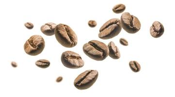 kaffebönor levitera på en vit bakgrund foto