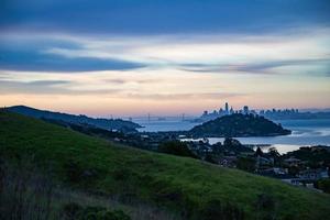 san francisco tidigt på morgonen skyline fog bay bridge foto