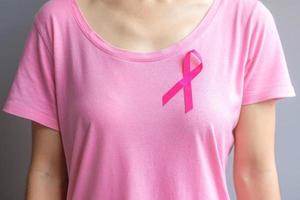 oktober månad för medvetenhet om bröstcancer, äldre kvinna i rosa t-shirt med rosa band för att stödja människor som lever och sjukdomar. internationella kvinnor, mor och världen cancer dag koncept foto