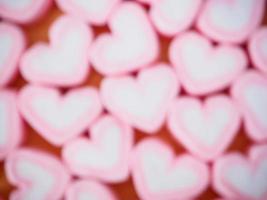oskärpa rosa hjärta form marshmallow för alla hjärtans bakgrund foto