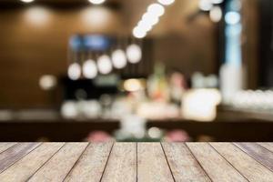 trä bordsskiva på oskärpa café restaurang med bokeh bakgrund foto